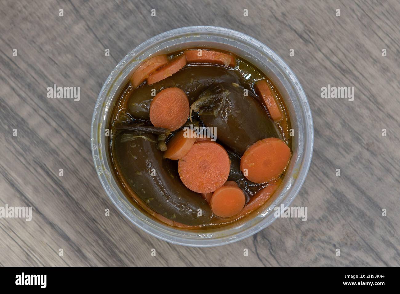 Overhead view of spicy side order container of jalapenos salsa to add some heat to the meal. Stock Photo