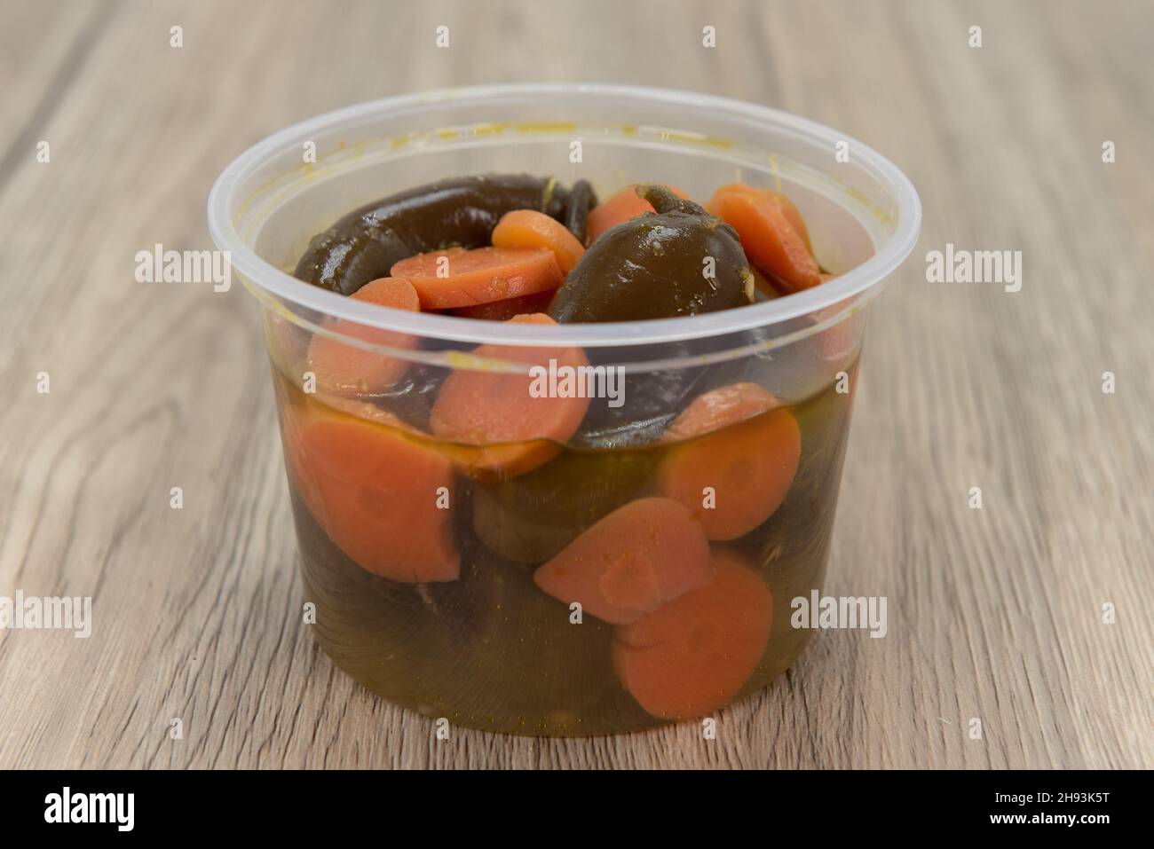 Spicy side order container of jalapenos salsa to add some heat to the meal. Stock Photo