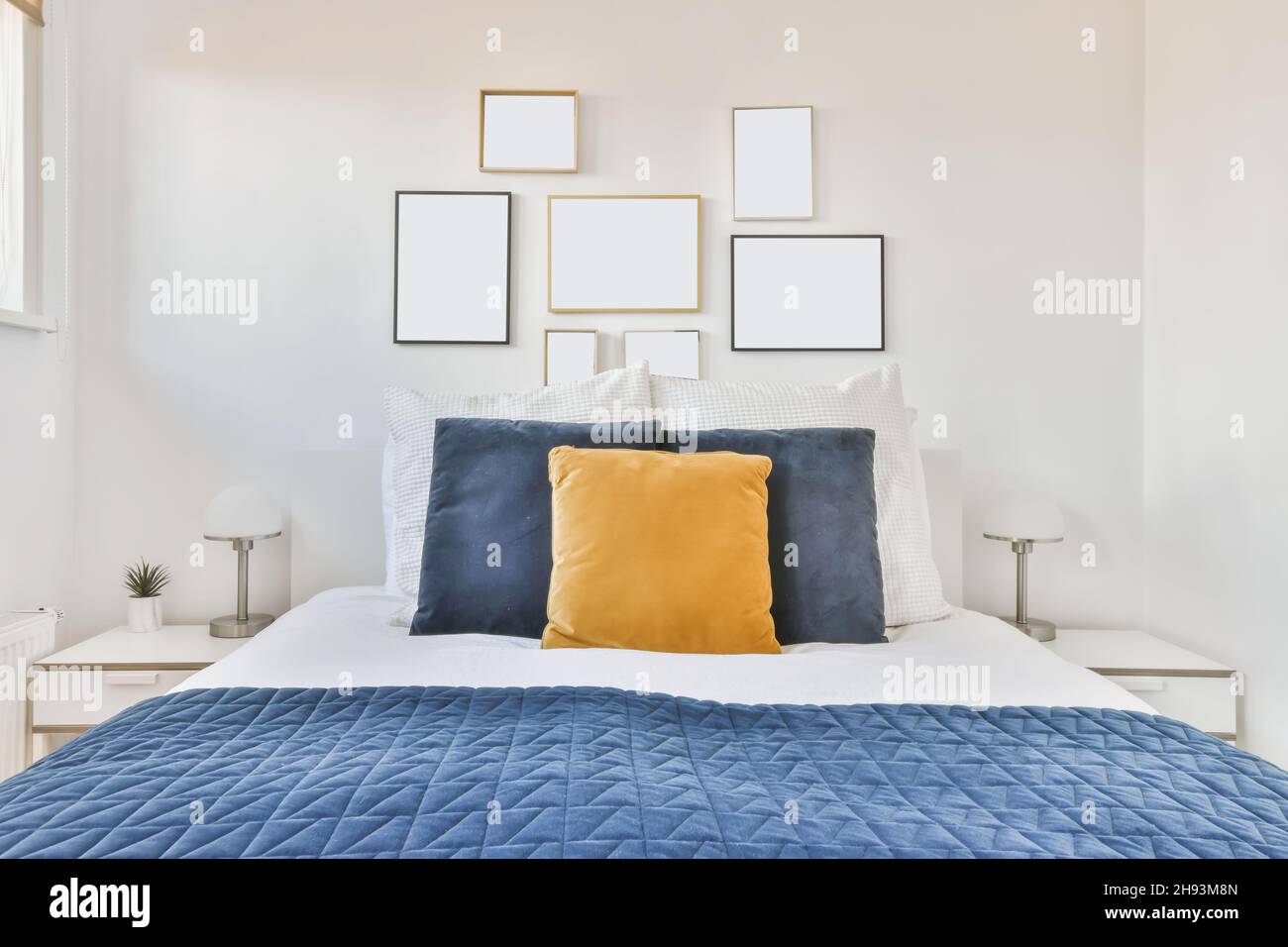 Luxurious bedroom with soft bed and blue bedspread Stock Photo
