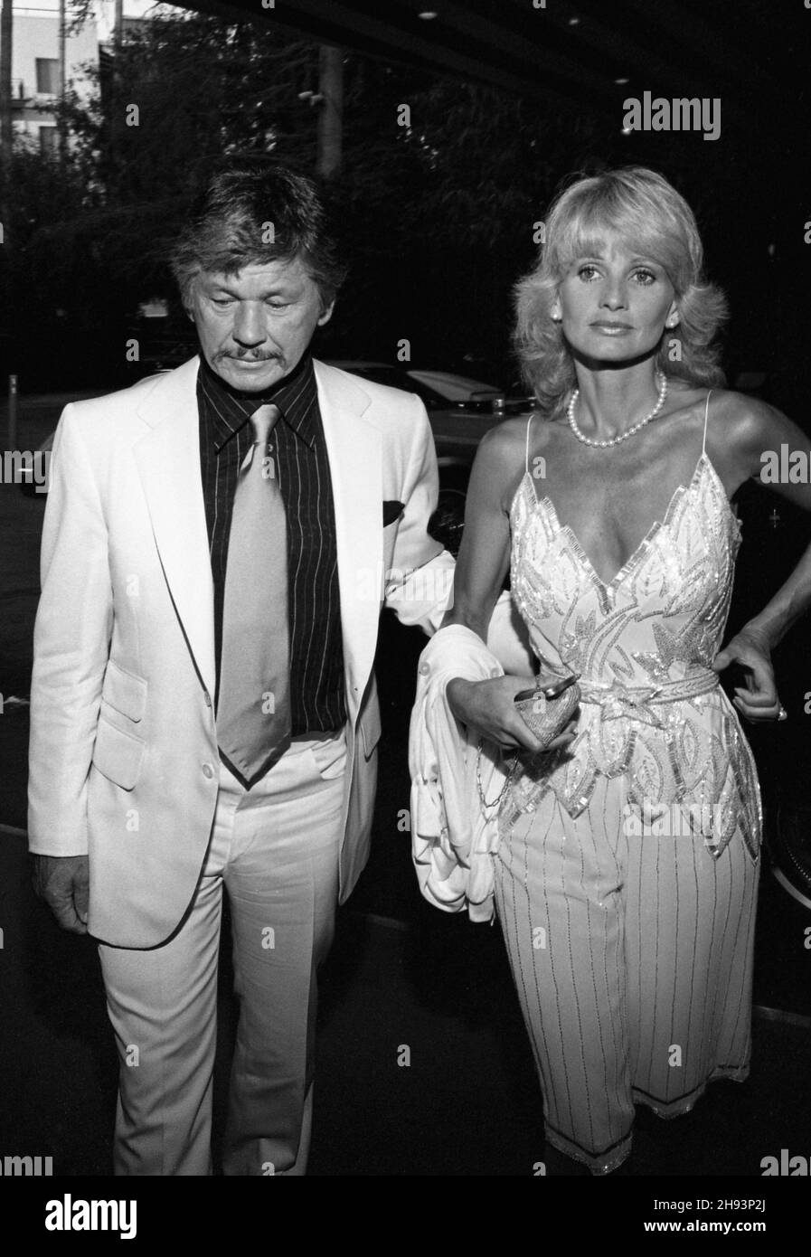 Charles Bronson and Jill Ireland  at the wedding reception for producer Al Ruddy and newspaper columnist Wanda McDaniel on June 21, 1981. Credit: Ralph Dominguez/MediaPunch Stock Photo