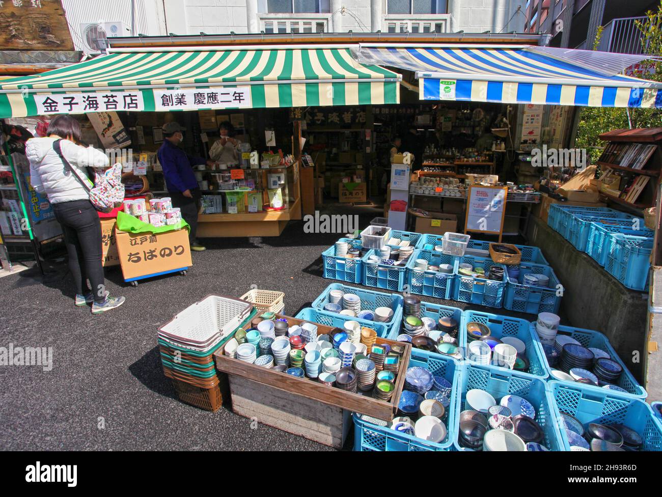 A person in a store that sells porcelain and crockery in one of the adjacent streets the the Tsukiji Fish Market in Tokyo. Stock Photo