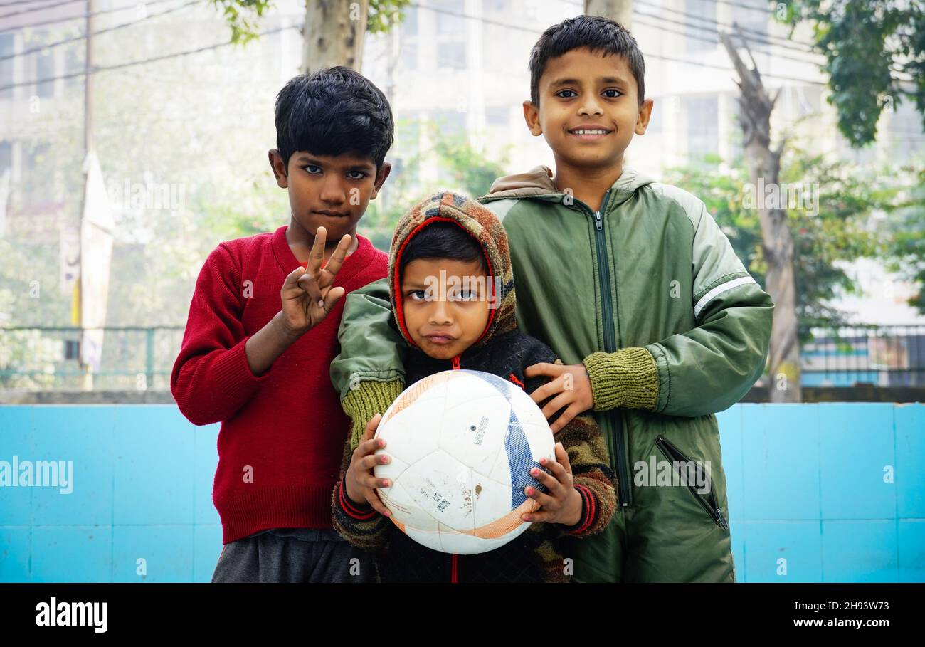 group of poor indian kids with football smiling Stock Photo
