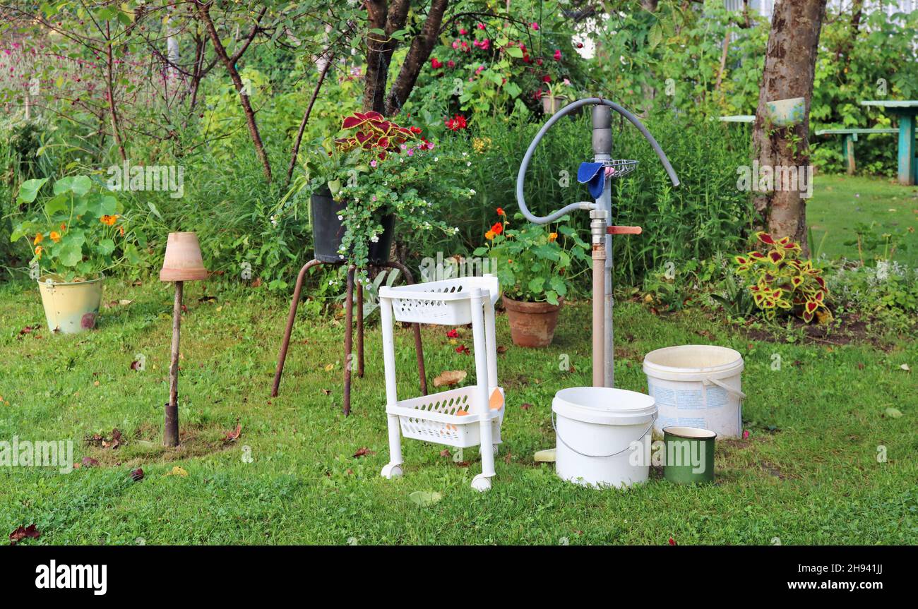 Hot  summer day and dirty  water in buckets in  poor  garden Stock Photo