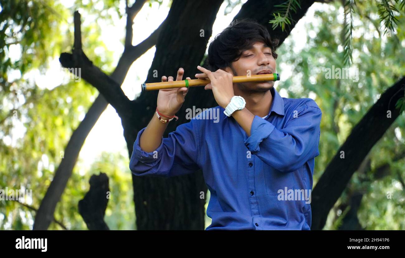 playing bansuri flute indian wind instrument Stock Photo Alamy