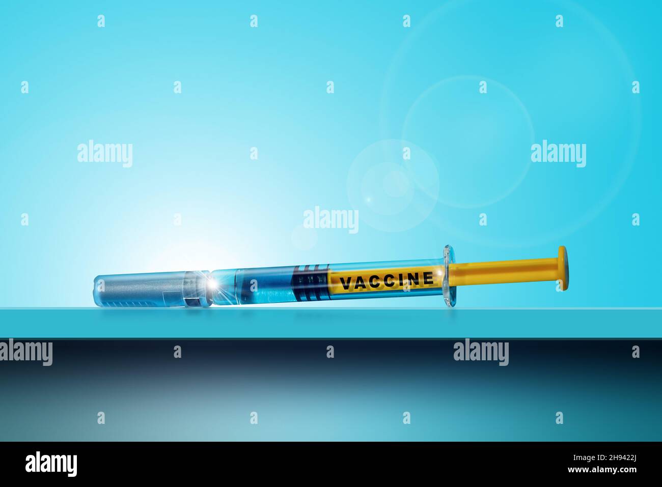 Close-up of a vaccine syringe on a blue table and background with copy ...