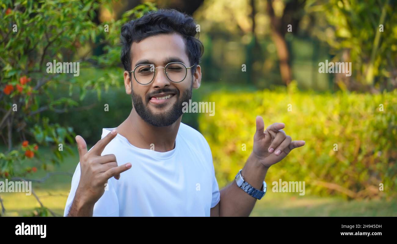 Young indian man sitting bench hi-res stock photography and images - Alamy