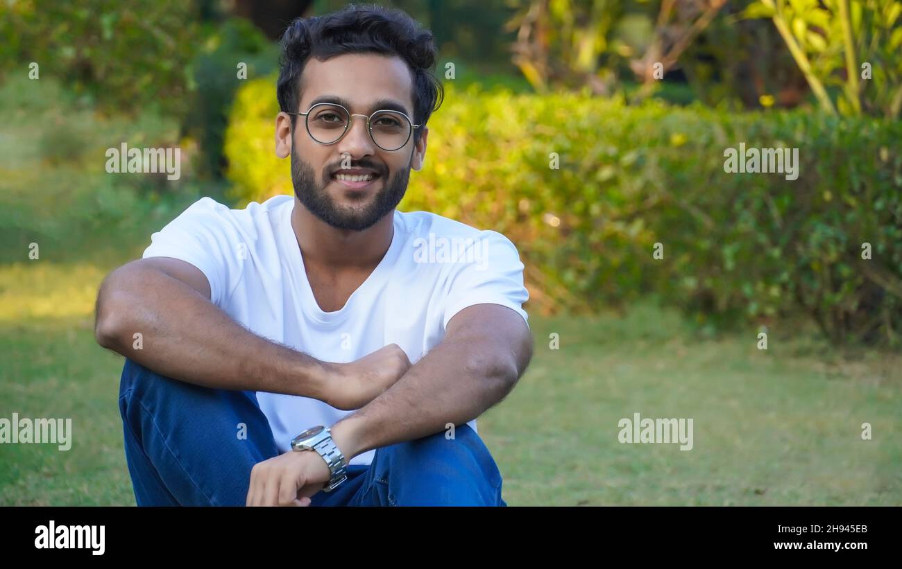 Young indian man sitting bench hi-res stock photography and images - Alamy