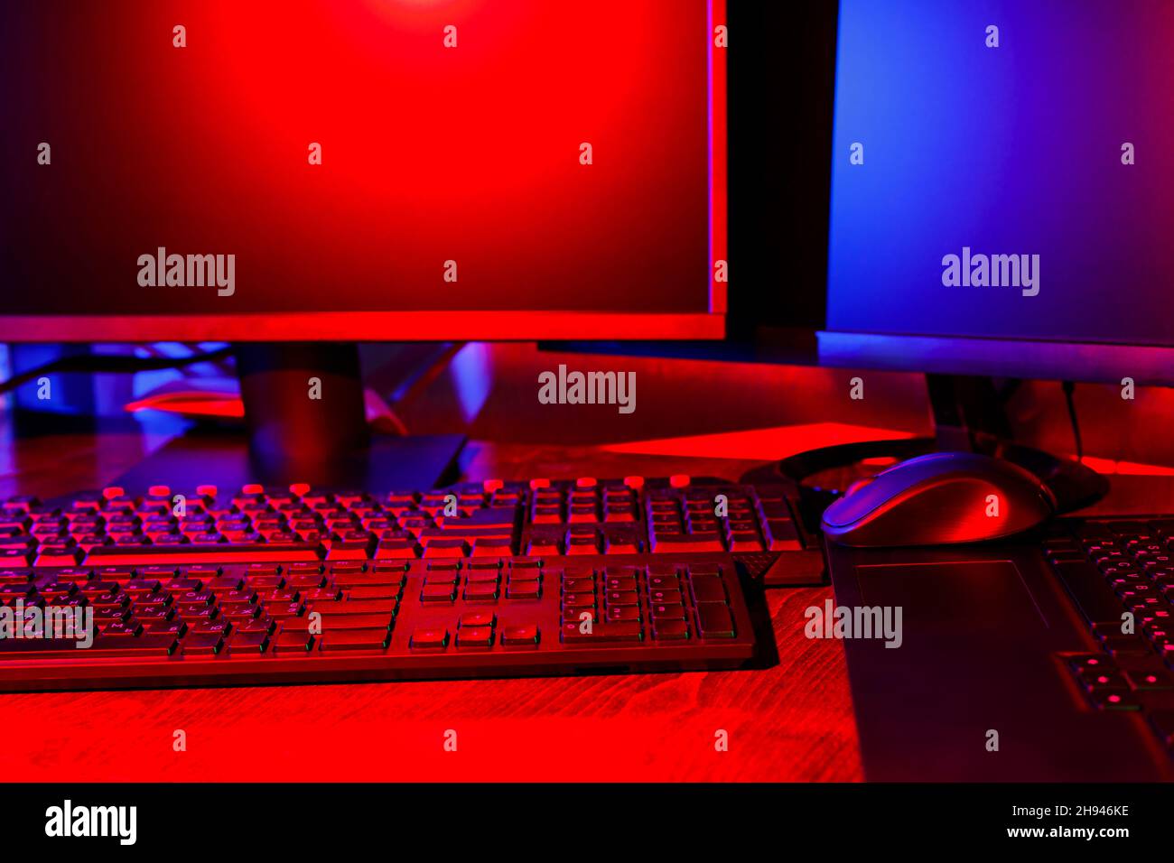 Creator's workplace in colored neon light. Computer equipment for ...