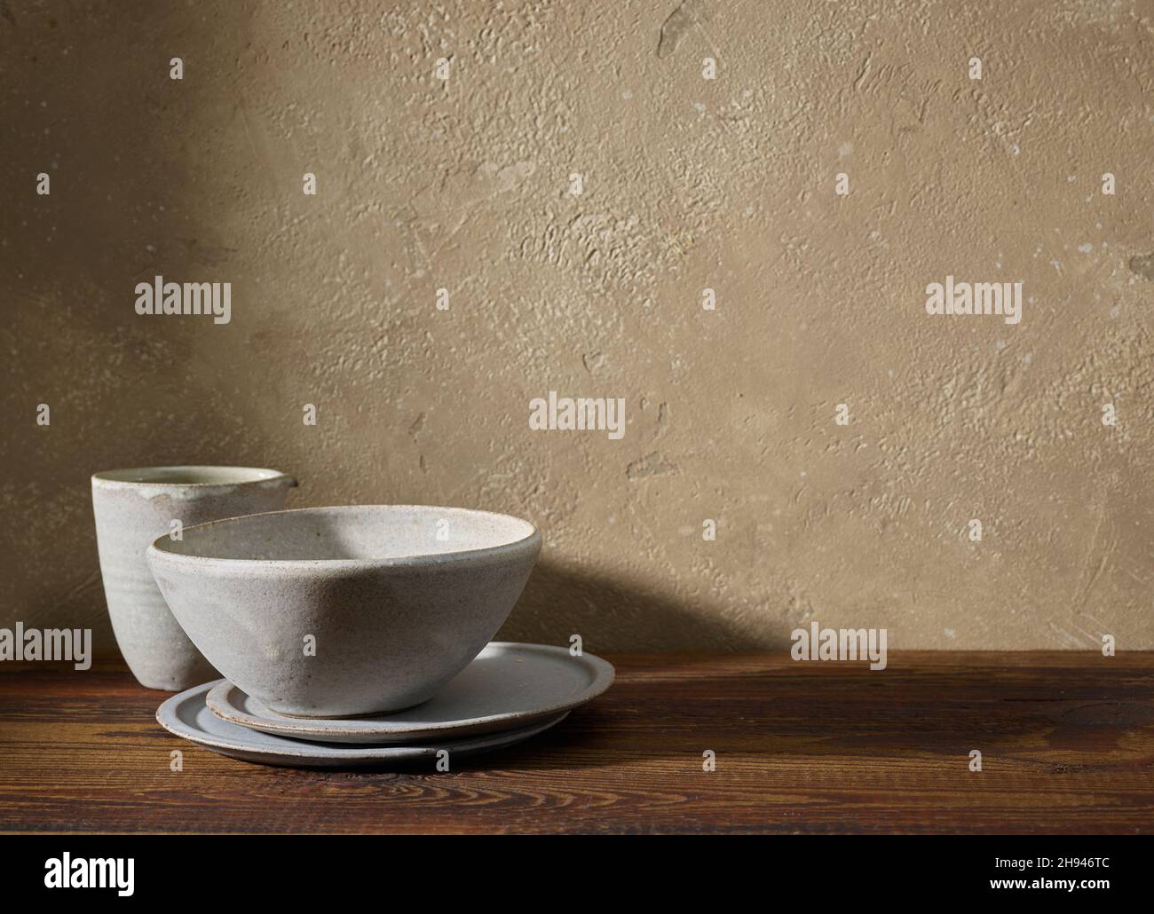 empty ceramic tableware on brown wooden shelf Stock Photo