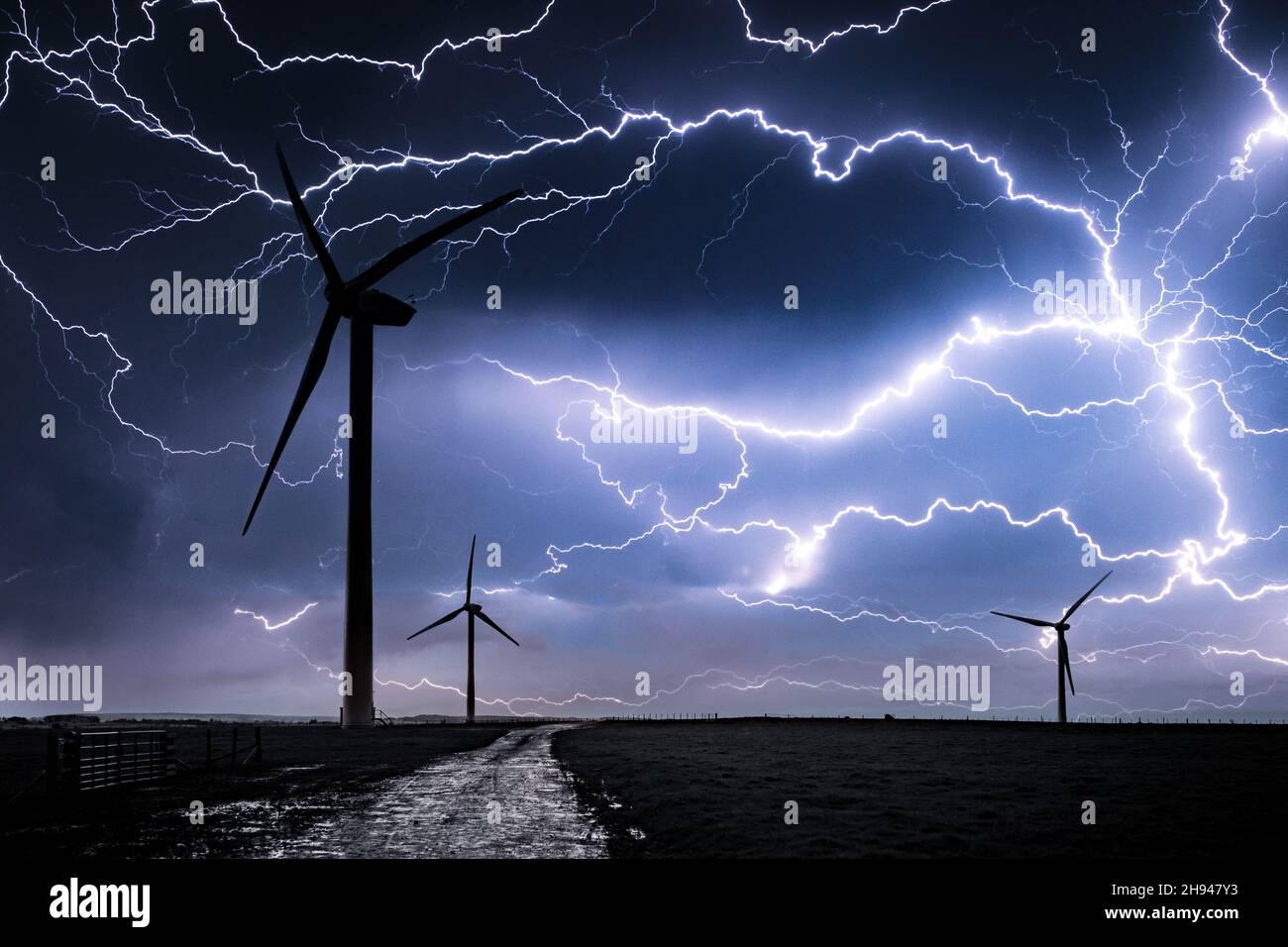 Lightning over Wind Farm. Storm over Wind Turbines. Stock Photo