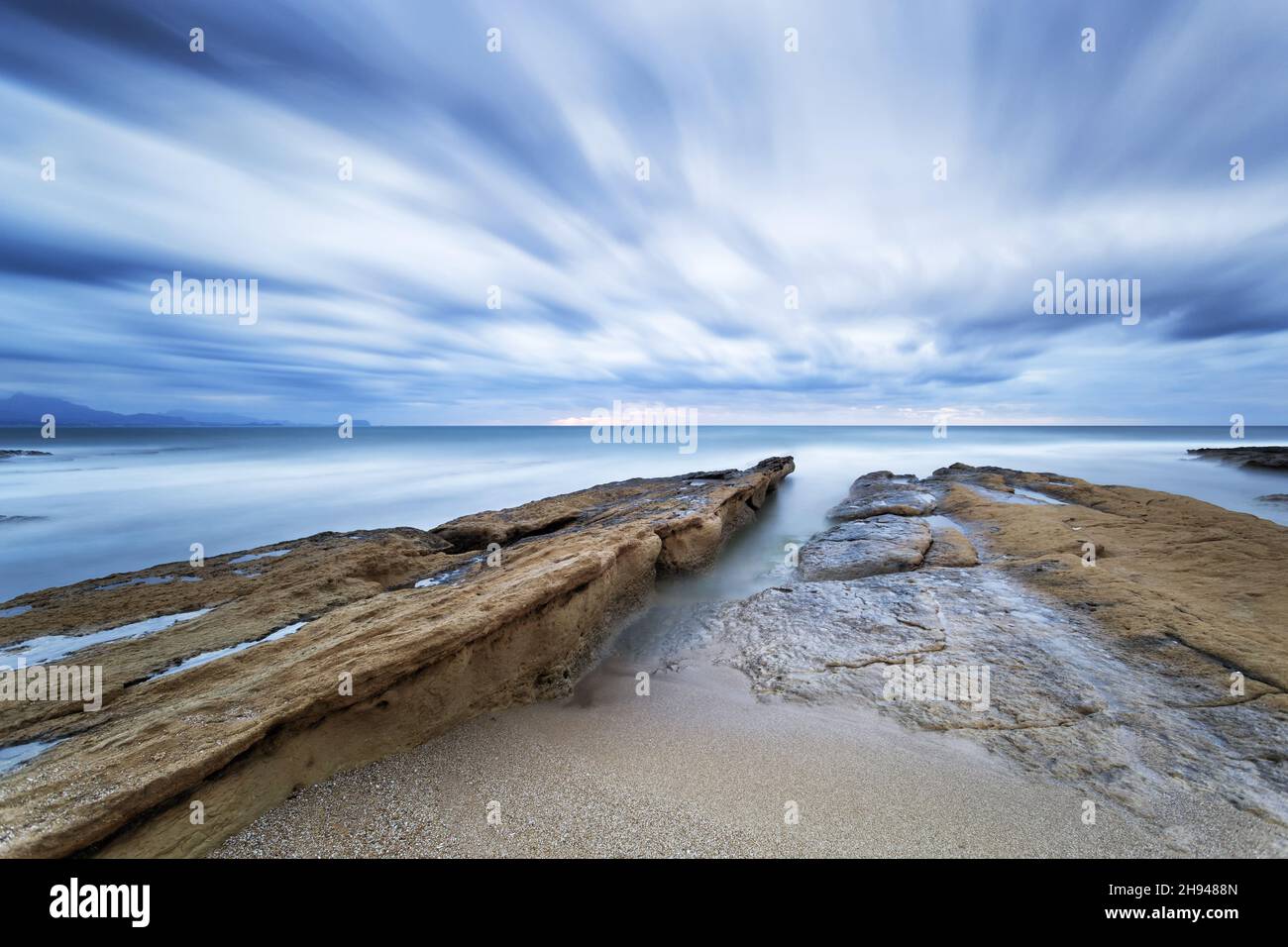 Beautiful scene of a beach under the dramatic cloudy sky Stock Photo ...