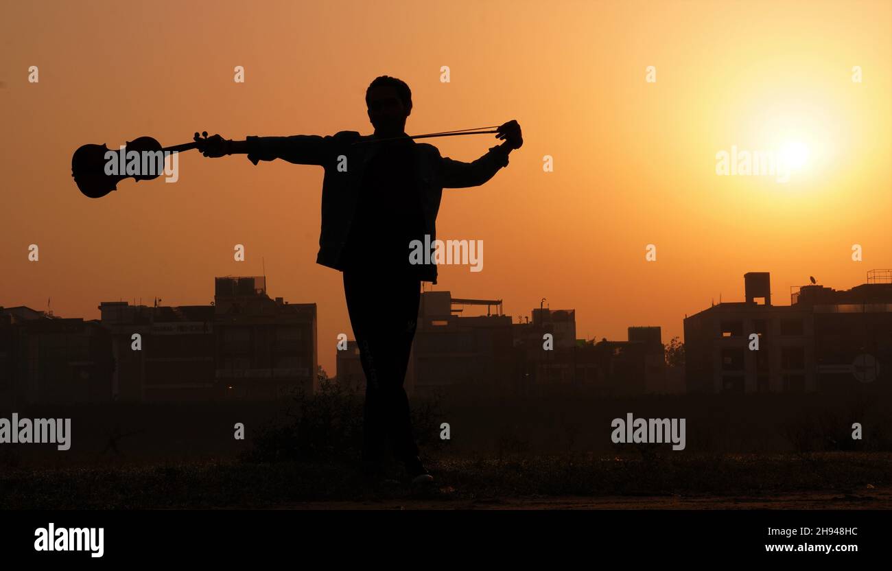 musician playing violin. Music and musical tone concept. silhouette images of man musician Stock Photo