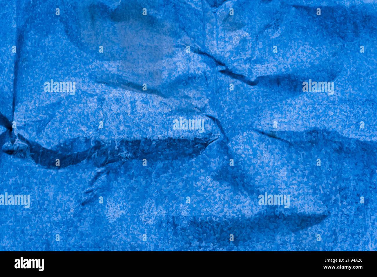 Dent on galvanized iron, dent on metal broken texture damaged background blue. Stock Photo