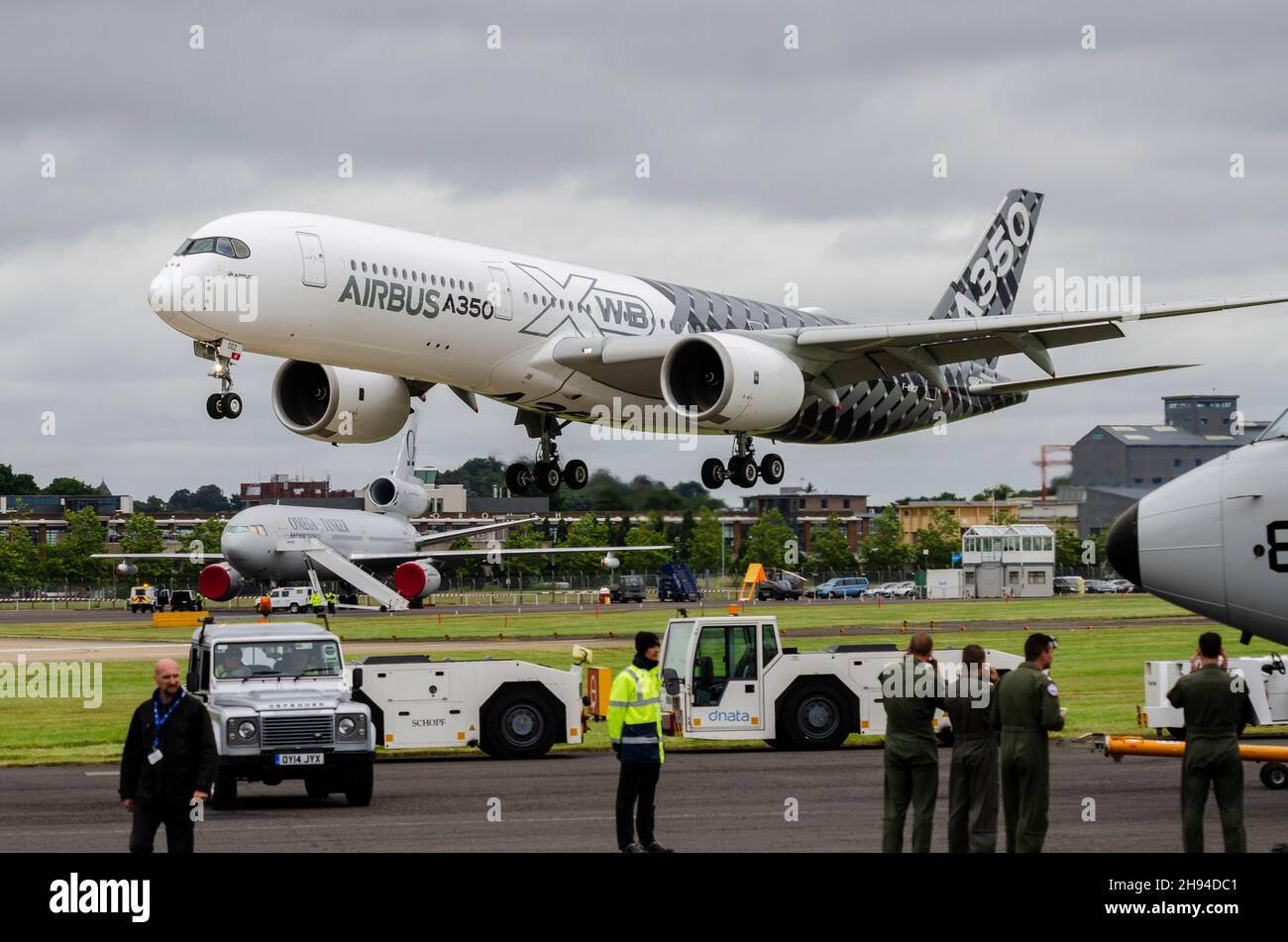 Airbus A350 XWB test aircraft in carbon fibre colour scheme landing at Farnborough International Airshow for demonstration display flights. Planes Stock Photo
