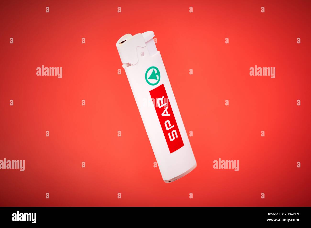spar cigarette Kaliningrad, Russia - 09.11.2021 - Pocket lighter with SPAR logo on red  background. Plastic lighter for cigarettes, fireworks, candles, campfire.  Disp Stock Photo