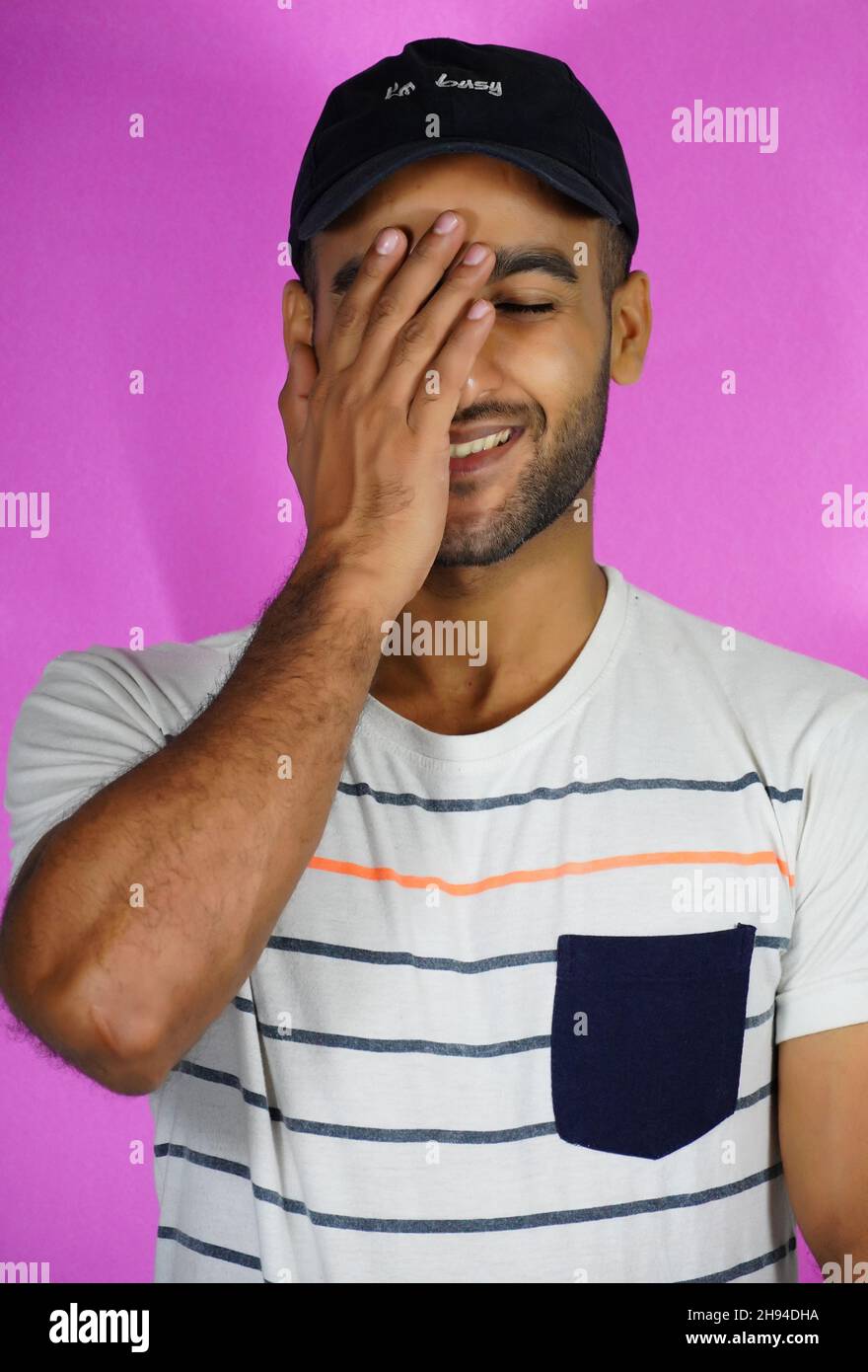 shy man image in pink background Stock Photo
