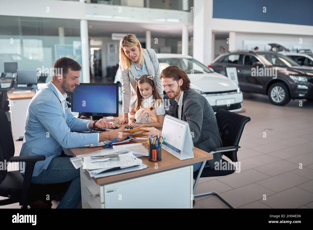 Delighted caucasian family buying a new car together for themselves Stock Photo