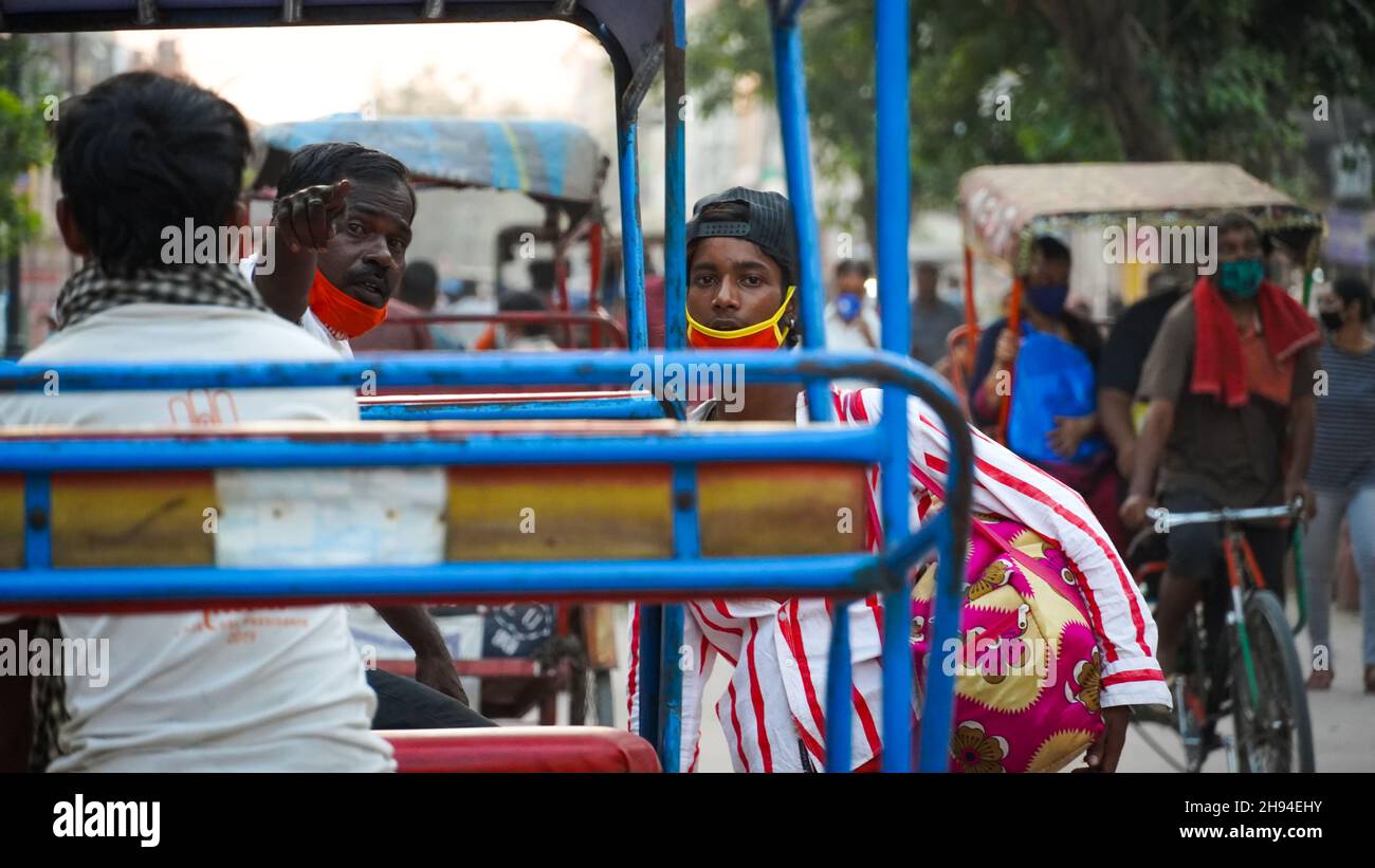 rickshaw driver guiding address in delhi india with mask due to corona Stock Photo
