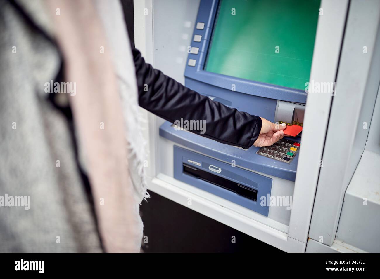 plastic credit card into street atm bank to withdraw money Stock Photo