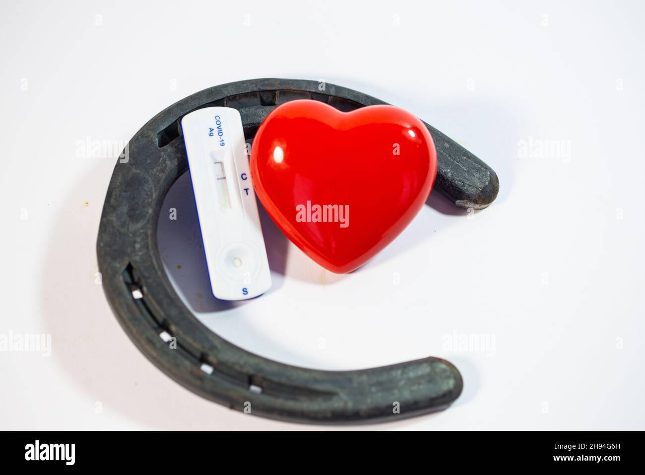 horseshoe with heart and covid test, good luck Stock Photo