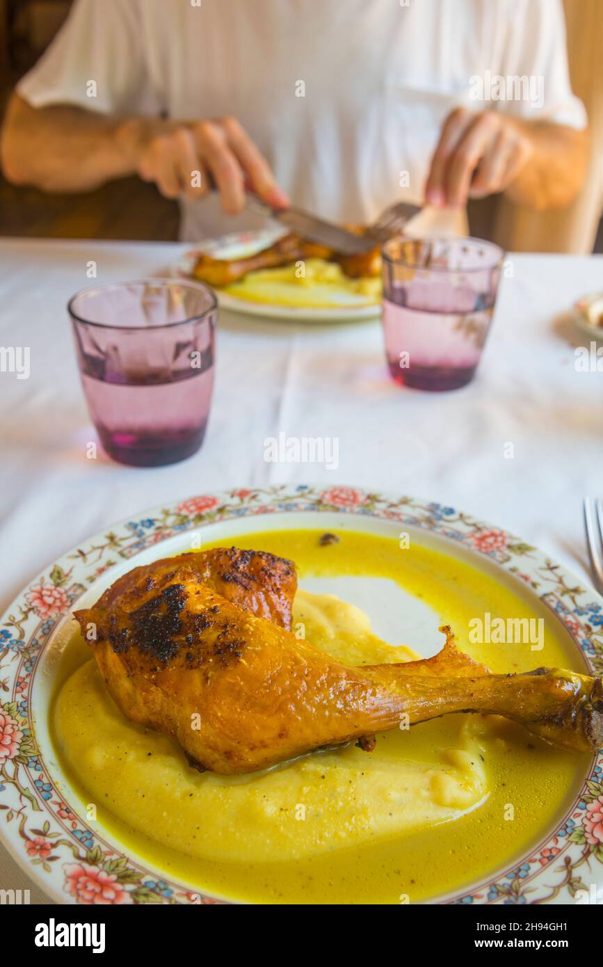 Eating roasted chicken with potato puree. Spain. Stock Photo