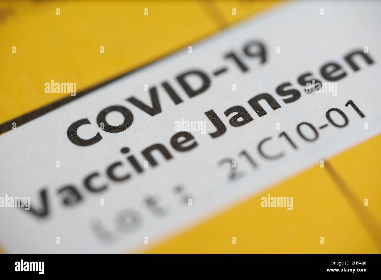 Stuttgart, Germany - May 15, 2021: 1 White sticker in a vaccination card. Confirmation of vaccination against corona virus covid-19. Yellow page in a Stock Photo