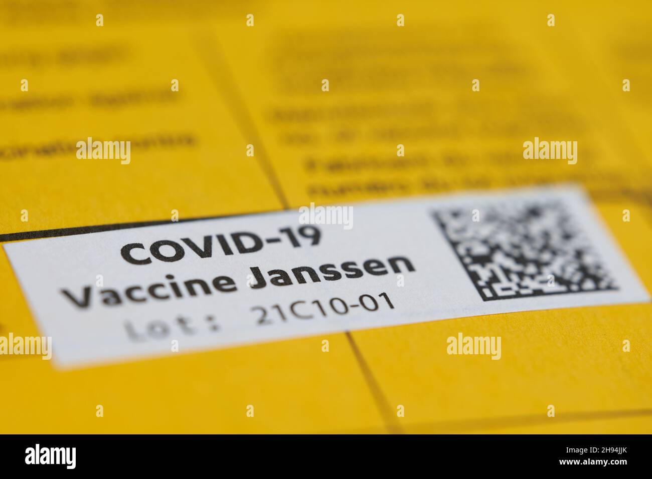 Stuttgart, Germany - May 15, 2021: 1 White etiquette in a vaccination card. Confirmation of vaccination against corona virus covid-19. Yellow page in Stock Photo