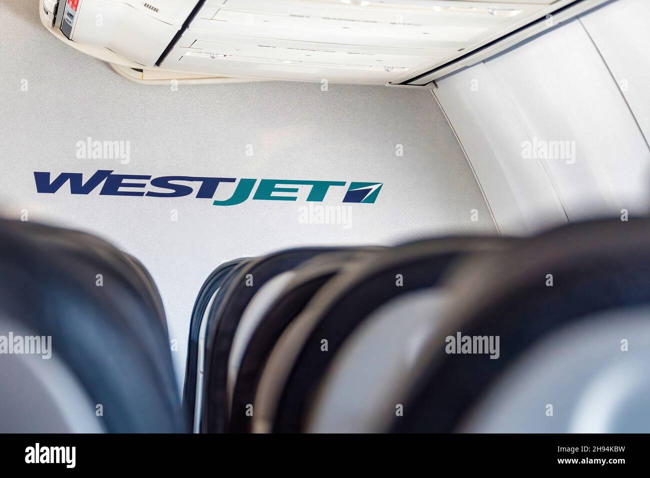 Interior of a Westjet plane. Logo of the company framed on empty seats. Nov. 22, 2021 Stock Photo