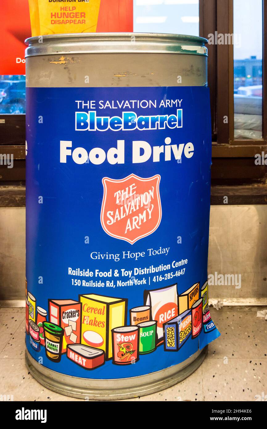 Food Drive Blue Barrel by the Salvation Army in a grocery store. The number of people visiting food banks in Toronto have increased noticeably. Stock Photo
