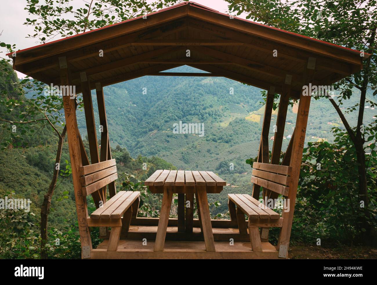Wooden gazebo, picnic, camping table and benches for Relaxation with view of Forest Stock Photo