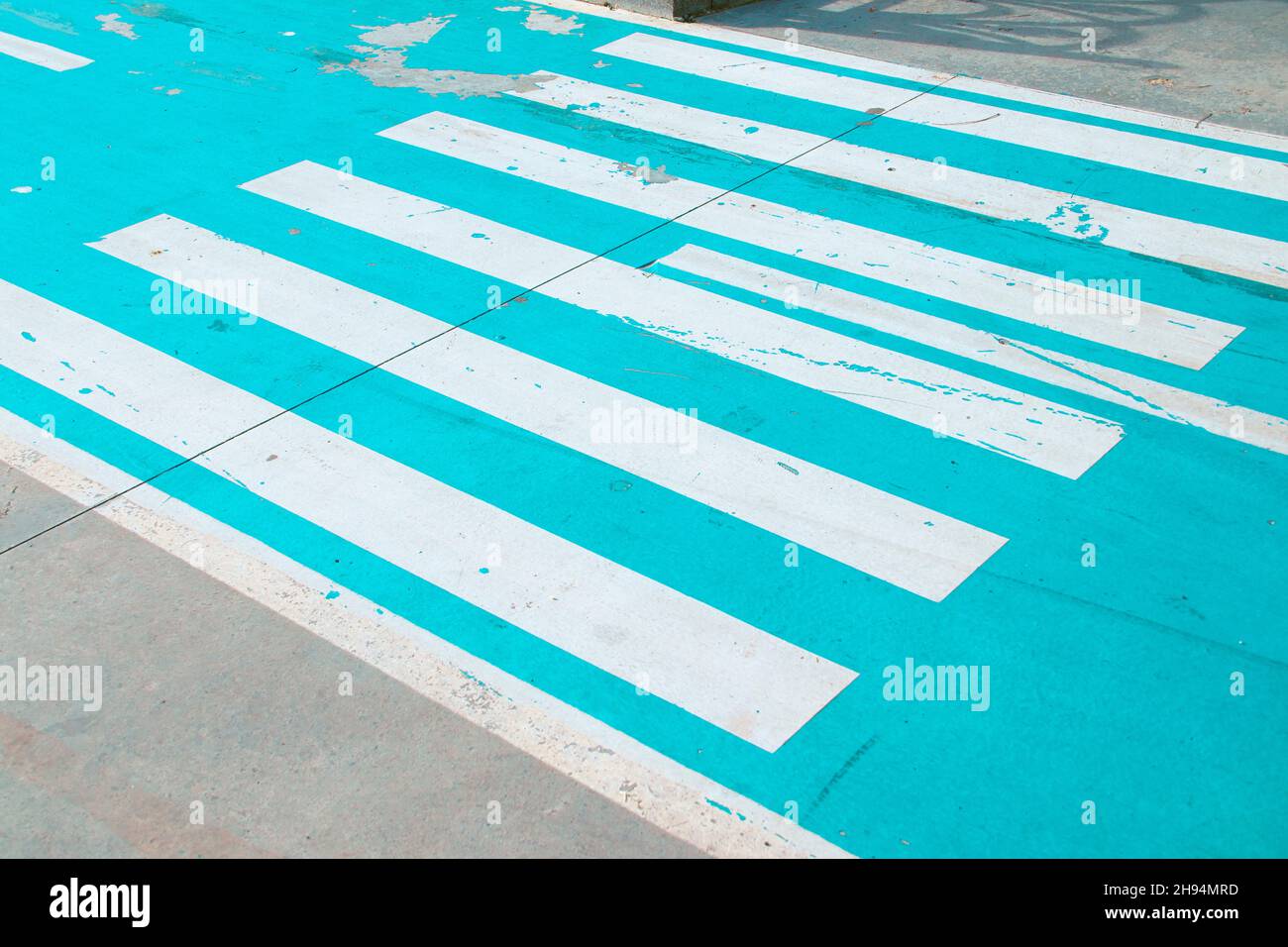 Crosswalk on bicycle road with blue background. Safety sign for cyclers and pedestrians. Stock Photo