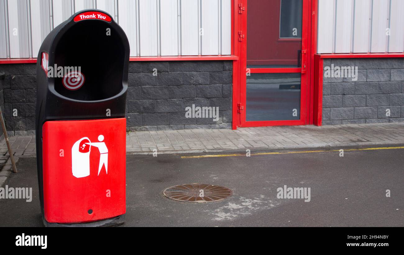 A large red trash can near the doors of the mall. Zero waste Stock