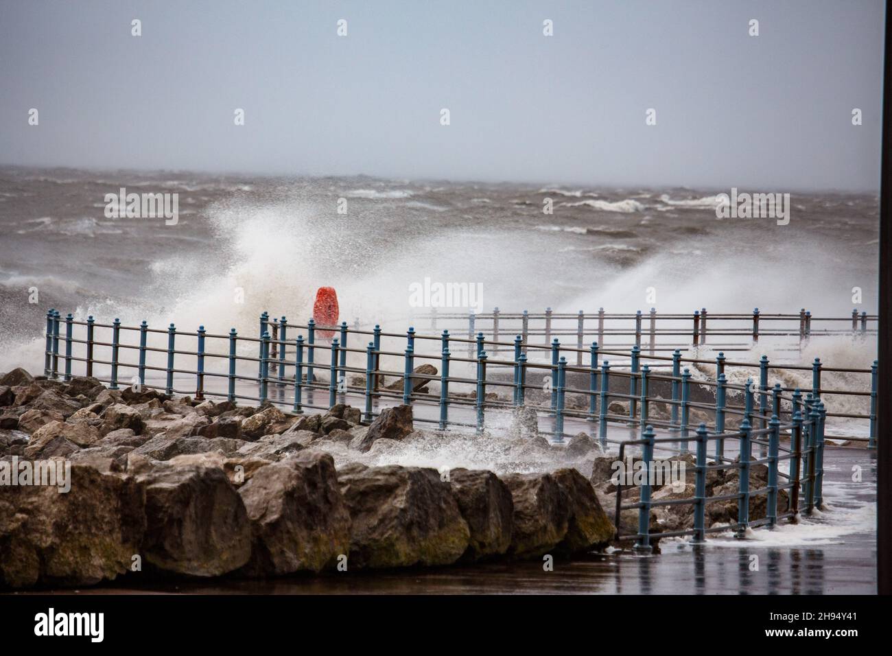 Heysham, Lancashire, UK. 4th Dec, 2021. Stron WInds brought over topping at high tide on the promenade at Heysham Credit: PN News/Alamy Live News Stock Photo