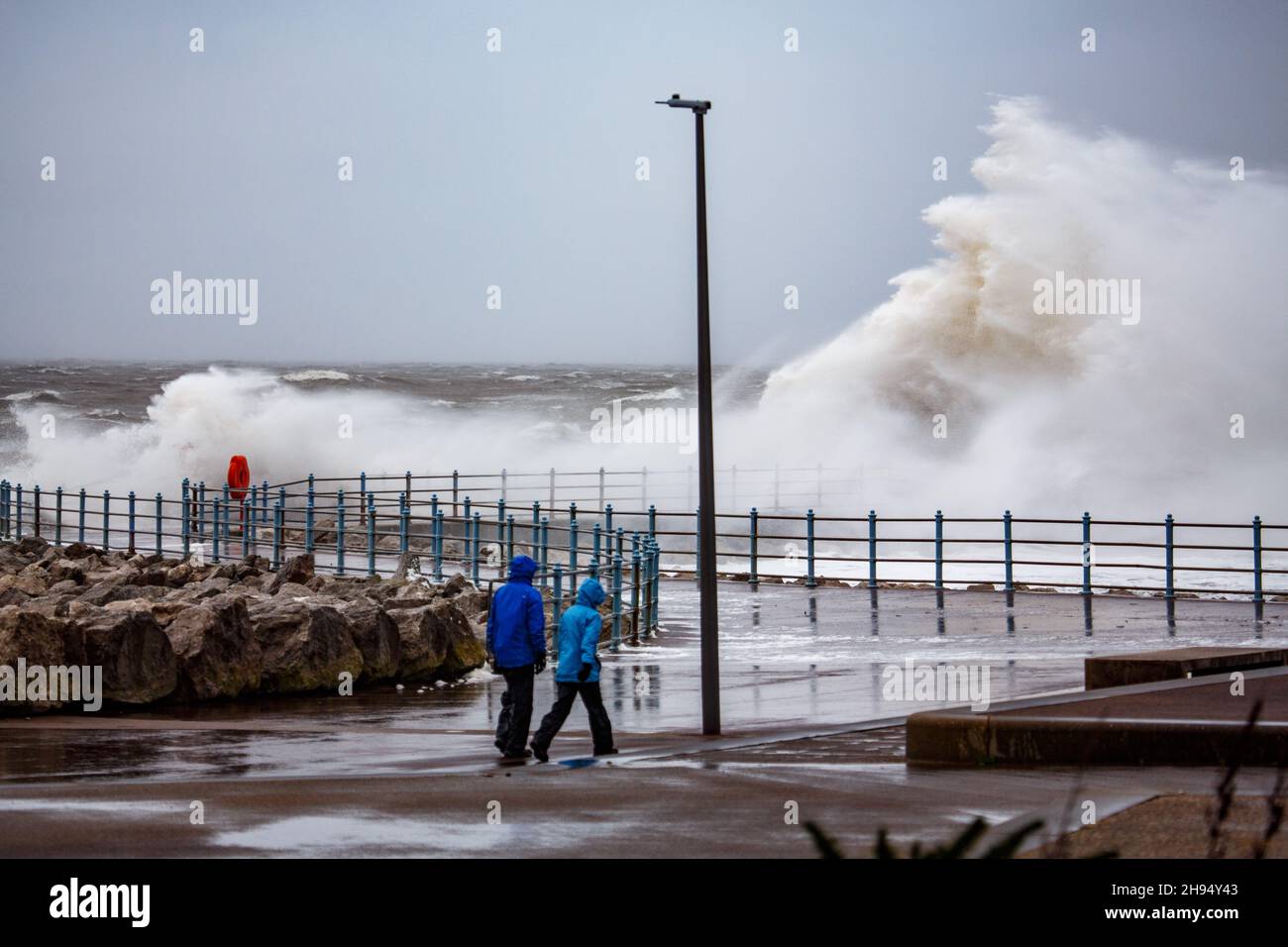 Heysham, Lancashire, UK. 4th Dec, 2021. Stron WInds brought over topping at high tide on the promenade at Heysham Credit: PN News/Alamy Live News Stock Photo