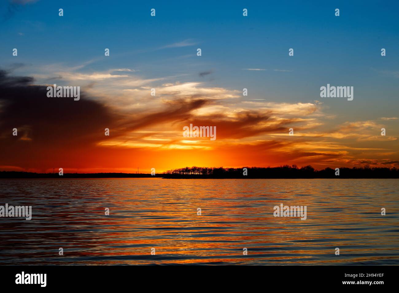 Cloudy sunset over a lake in Oklahoma. Stock Photo