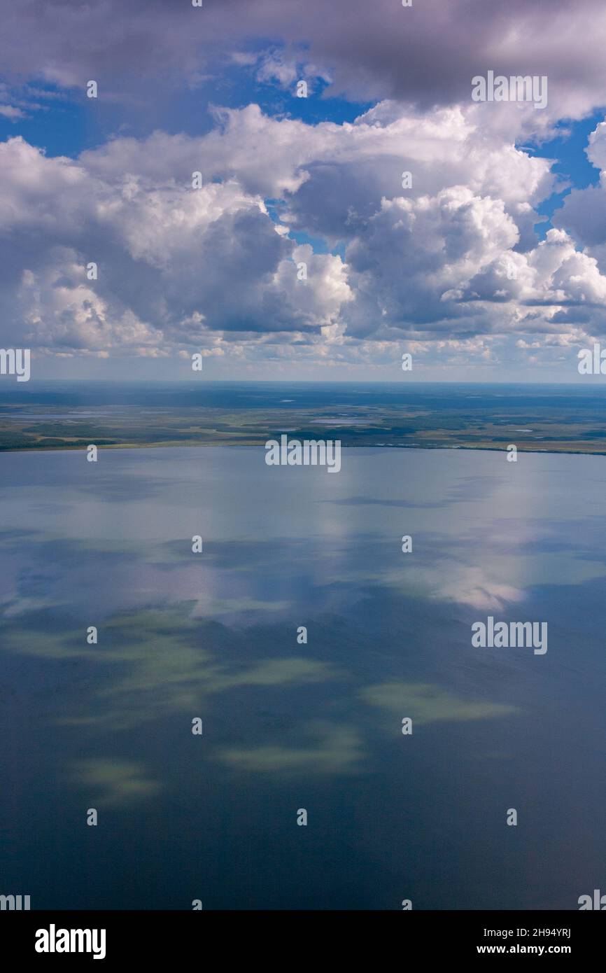 Aerial view of lake under cumulus clouds on hot summer day Stock Photo ...