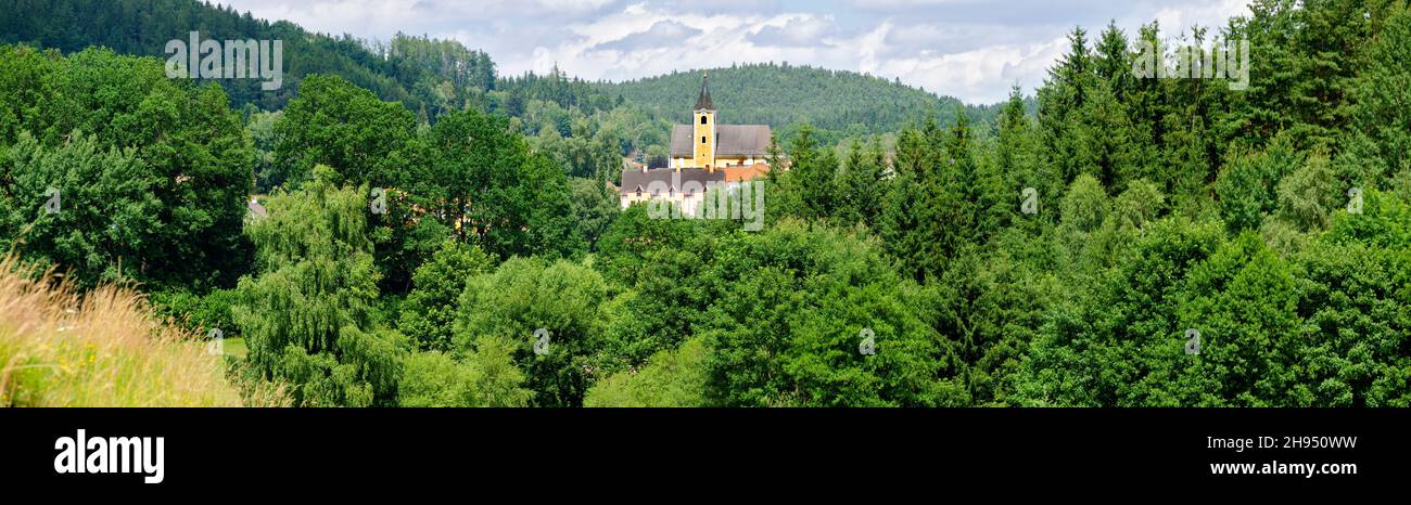 panorama of a wooden landscape with the church of a small village in the center in the region Waldviertel (forestquarter) Austria Stock Photo