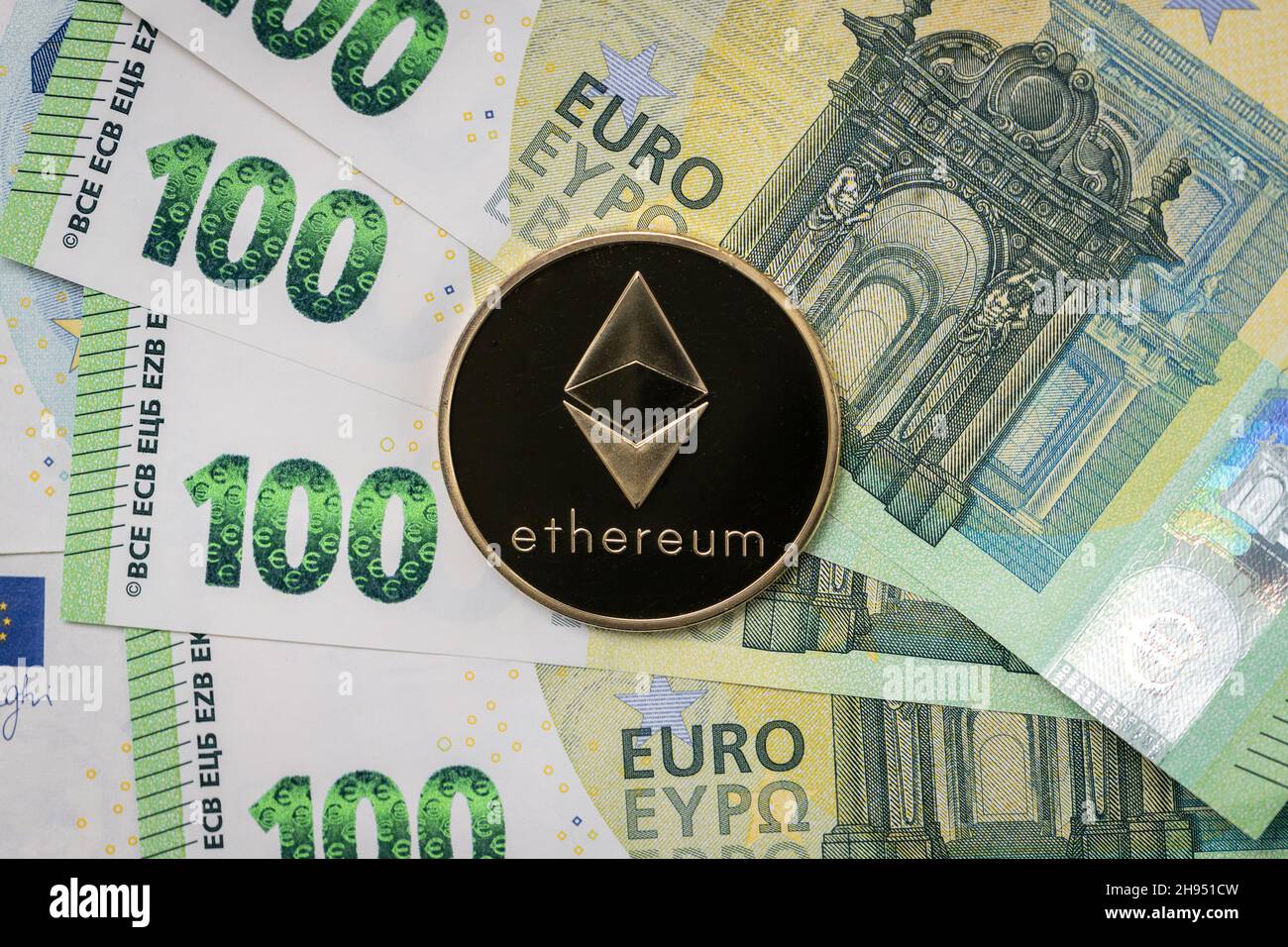 Ethereum physical coin laying on top of 100 Euro bills Stock Photo - Alamy