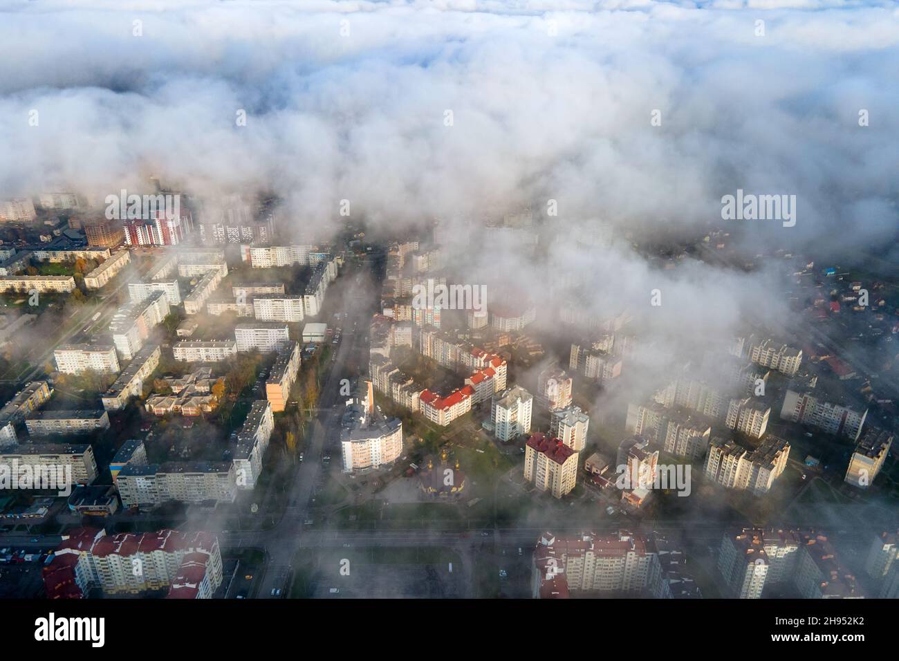 Top aerial view of fluffy white clouds over modern city with high rise ...