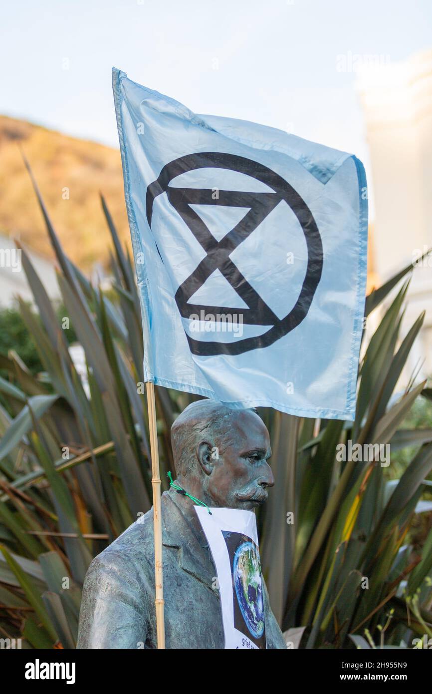 Great Malvern, Worcestershire, UK. 4th Dec, 2021. An Extinction Rebellion flag is attached to the bronze statue of Sir Edward Elgar in Bell Vue Terrace Island, Great Malvern, Worcestershire. The famous English composer is an unwitting supporter of the climate activists XR Malvern aims, as his statue bears the XR flag and a poster which reads 'grief and love for the Earth'. Credit: Peter Lopeman/Alamy Live News Stock Photo