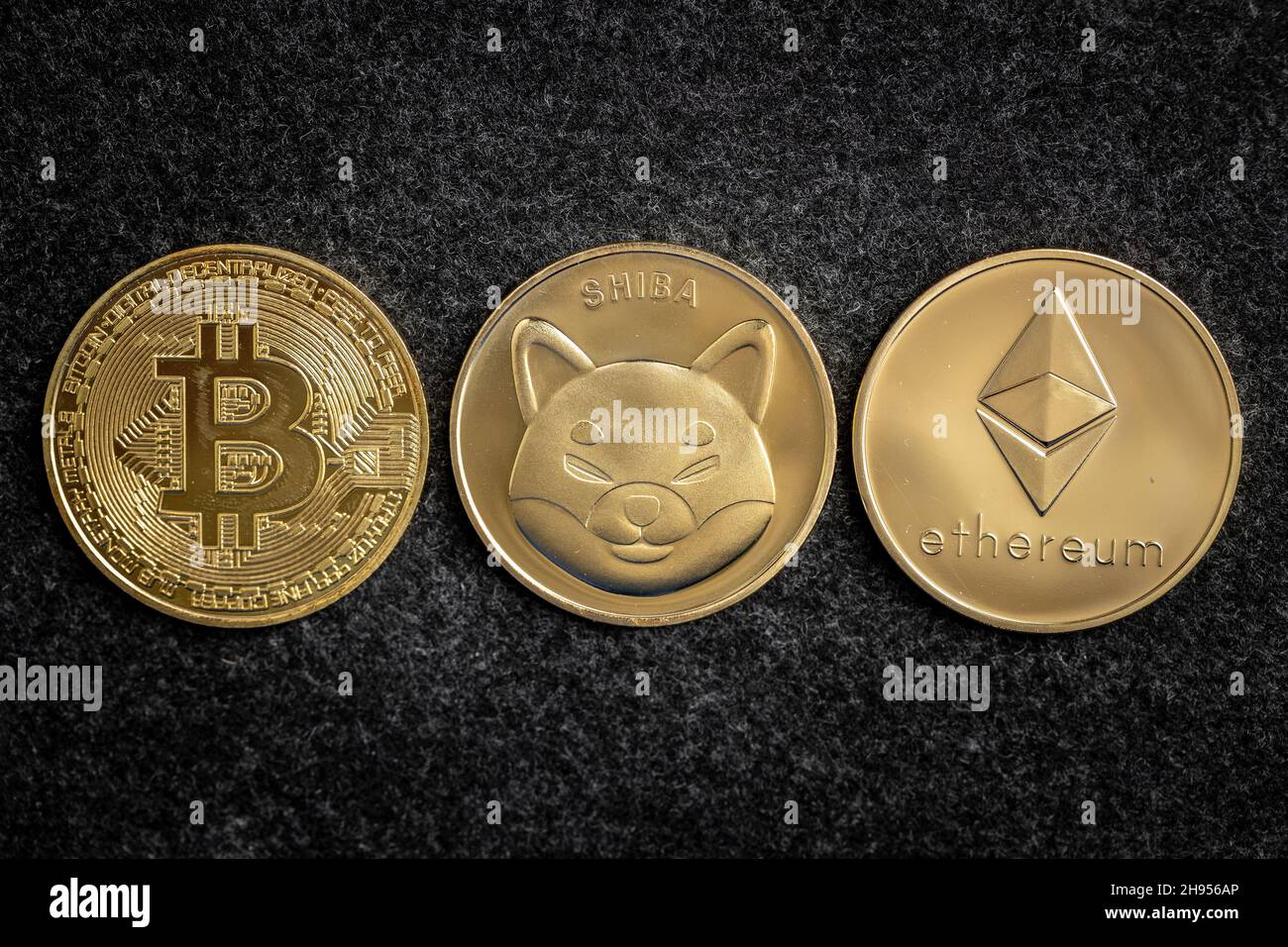 Shiba Inu Coin between Bitcoin and Ethereum physical coins Stock Photo -  Alamy