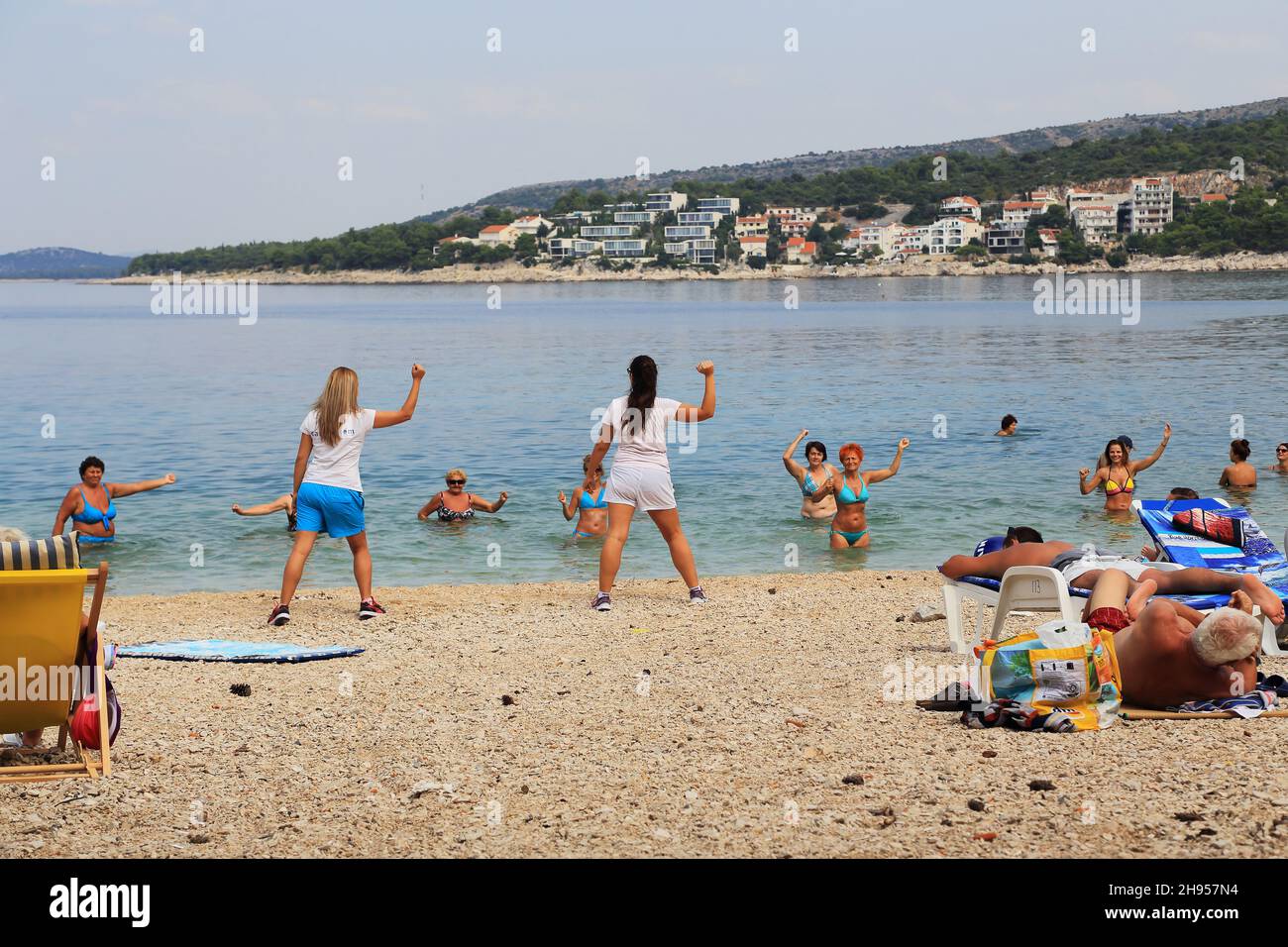 PRIMOSTEN, CROATIA - SEPTEMBER 10, 2016: Unidentified animators play an aerobics class on the beach. Stock Photo