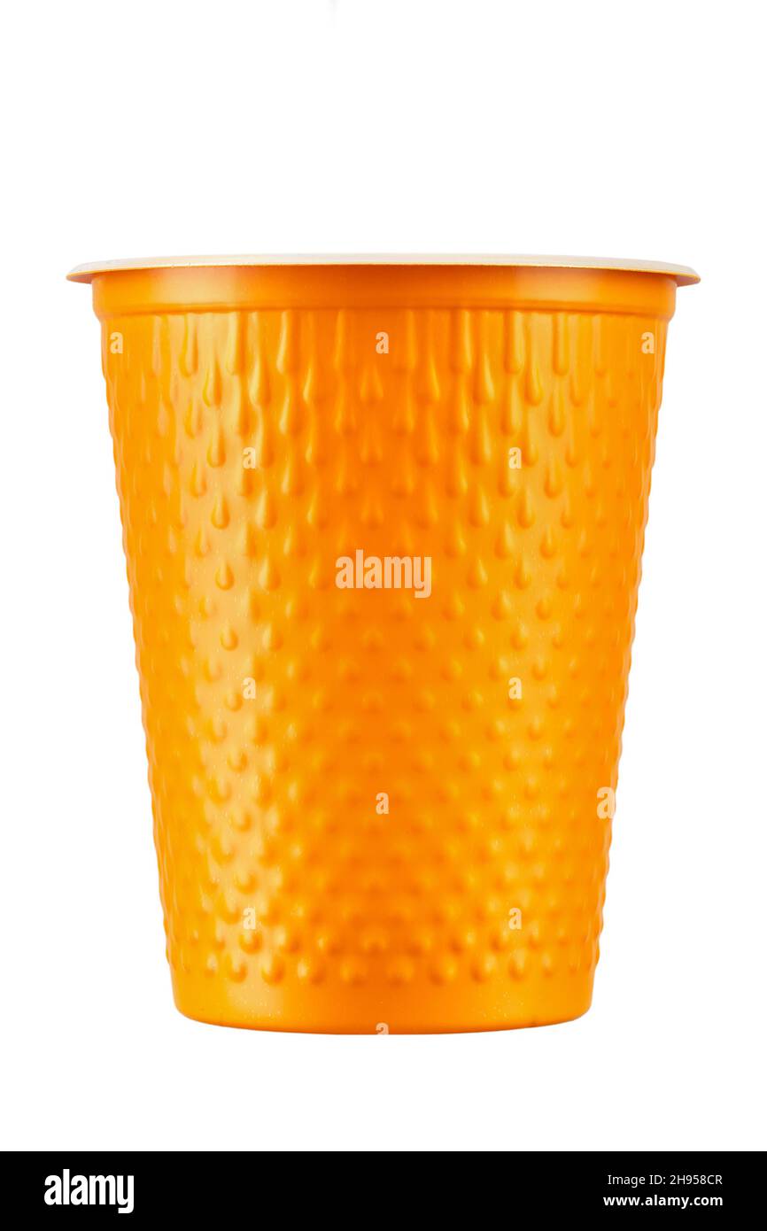 New orange plastic cup on white background. Disposable tableware. File