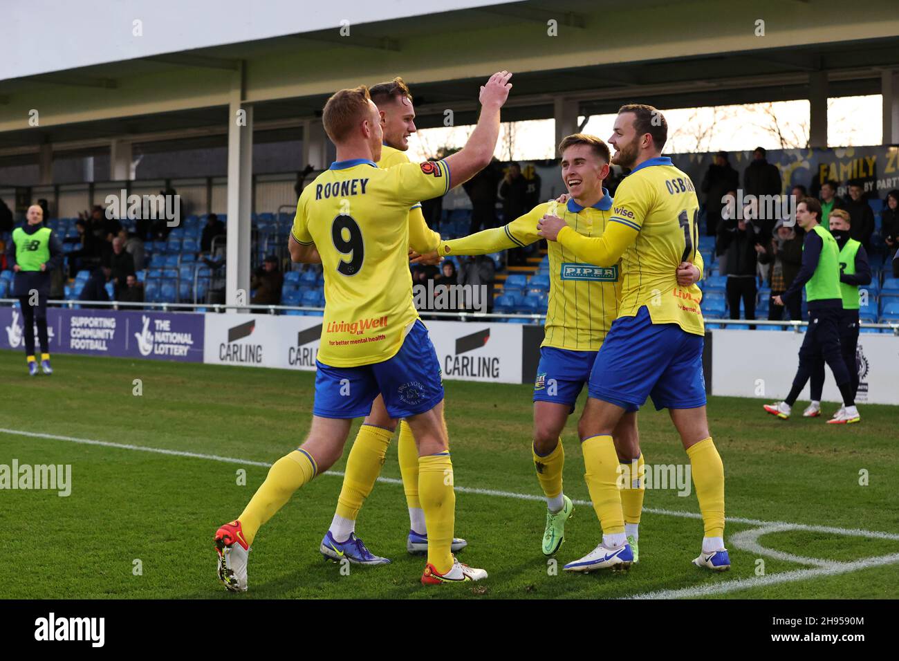 SOLIHULL, ENGLAND. DECEMBER 4TH 2021. Joe Sbarra of Solihull Moors (second right) celebrates with teammates after scoring his sides first goal during the Vanarama National League match between Solihull Moors and Woking FC at the Armco Stadium, Solihull on Saturday 4th December 2021. (Credit: James Holyoak/Alamy Live News) Stock Photo