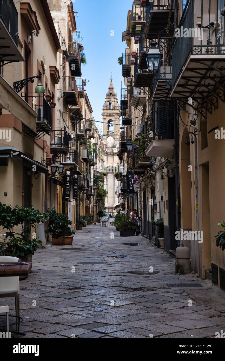 View of a church tower at the end of an alley in the historic center of Palermo Stock Photo