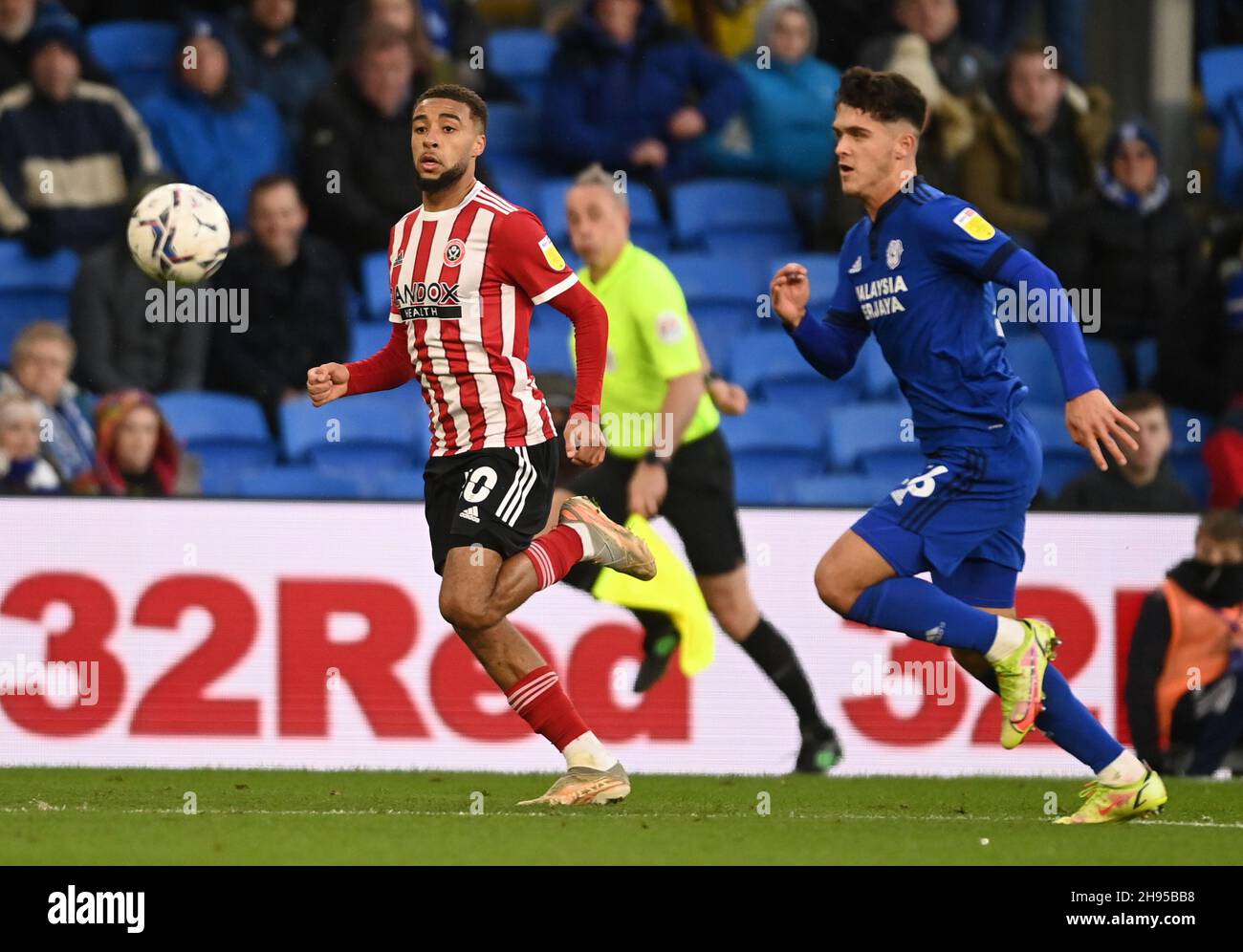 Cardiff, Wales, 4th December 2021.  Jayden Bogle of Sheffield Utd runs through behind Ryan Giles of Cardiff City during the Sky Bet Championship match at the Cardiff City Stadium, Cardiff. Picture credit should read: Ashley Crowden / Sportimage Credit: Sportimage/Alamy Live News Stock Photo