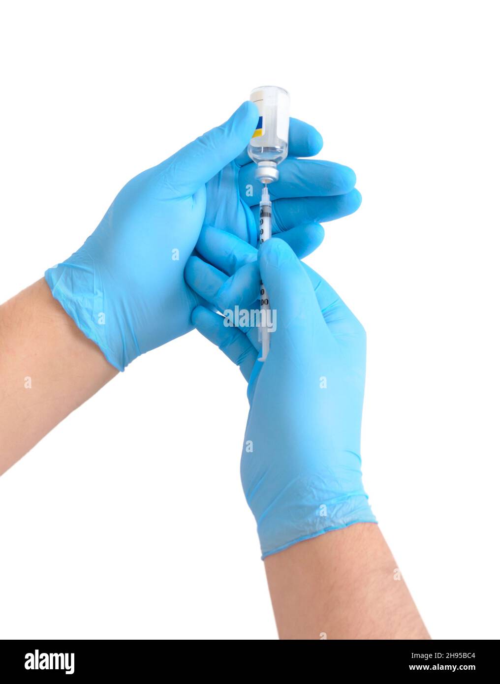 Taking drugs or vaccines into a syringe. Isolated on white background. Stock Photo