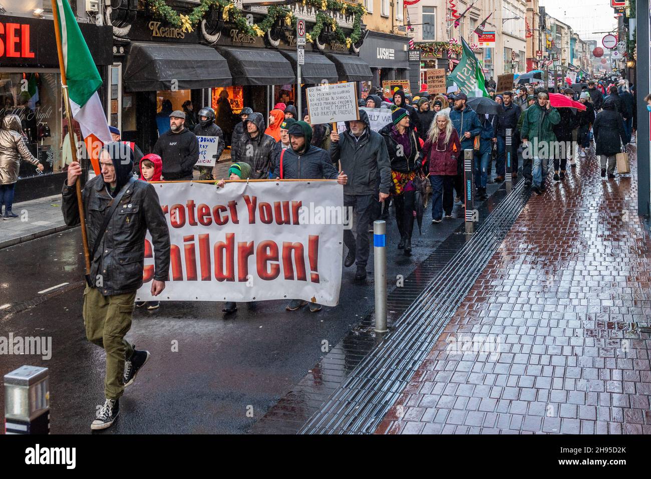 Cork, Ireland. 4th Dec, 2021. Around 500 people held a protest in Cork city today against lockdown; vaccinations for children; vaccine passports and face masks. The protestors marched around Cork city centre chanting and waving signs. It comes as the government has imposed restrictions on hospitality and household mixing until 9th January. Credit: AG News/Alamy Live News Stock Photo