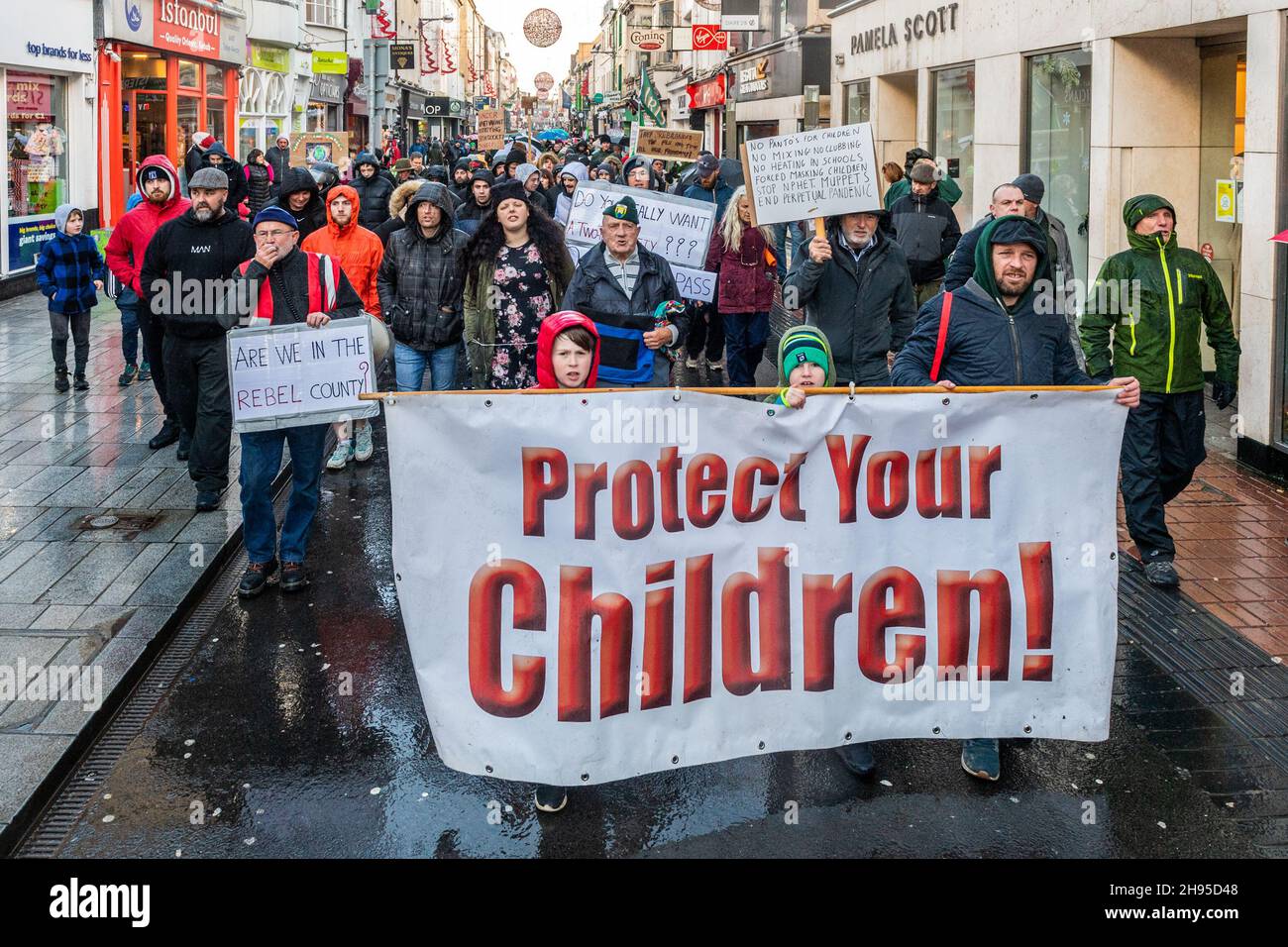 Cork, Ireland. 4th Dec, 2021. Around 500 people held a protest in Cork city today against lockdown; vaccinations for children; vaccine passports and face masks. The protestors marched around Cork city centre chanting and waving signs. It comes as the government has imposed restrictions on hospitality and household mixing until 9th January. Credit: AG News/Alamy Live News Stock Photo