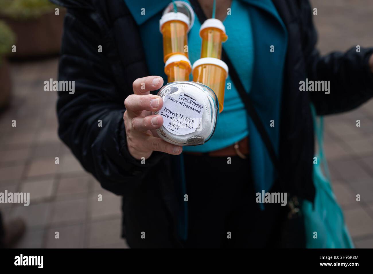 Susan Stevens carries her daughter Toria's ashes around her neck since she died of an opiod overdose in 2018. On December 3, 2021, people from across the United States, who lost loved ones due to the opioid epidemic, rallied at the Department of Justice in Washington DC, calling on Attorney General Merrick Garland and Deputy AG Lisa Monaco to bring criminal charges against members of the Sackler family. The Sackler's company, Purdue Pharma, pleaded guilty in October of 2020, to three criminal charges related to its marketing of the drug OxyContin but have only faced monetary penalties of aroun Stock Photo